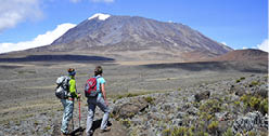 Two women overlook the Marangu Route on Mt  Kilimanjaro in Tanzania 