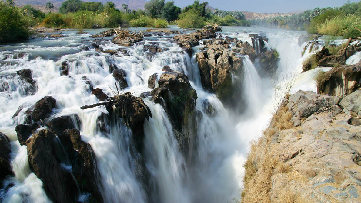 Epupa Falls (also known as Monte Negro Falls in Angola) is a series of large waterfalls created by the Cunene River on the border of Angola and Namibia, in the Kaokoland area of the Kunene Region 
