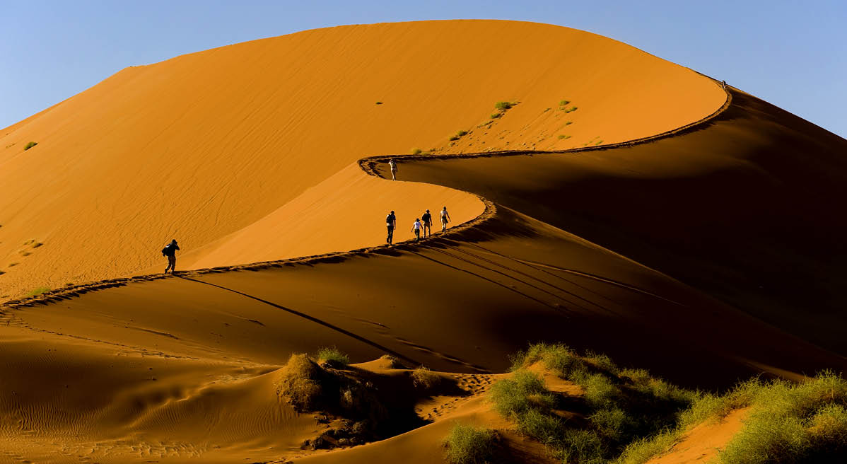 Tourists climbing Sossusvlei dune, Naukluft National Park, Namibia