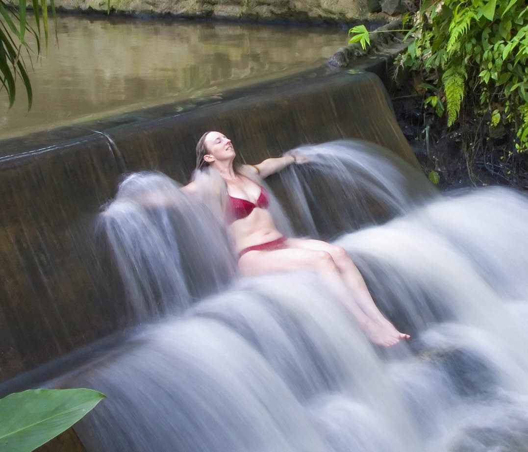 Long exposure of a woman in a river waterfall