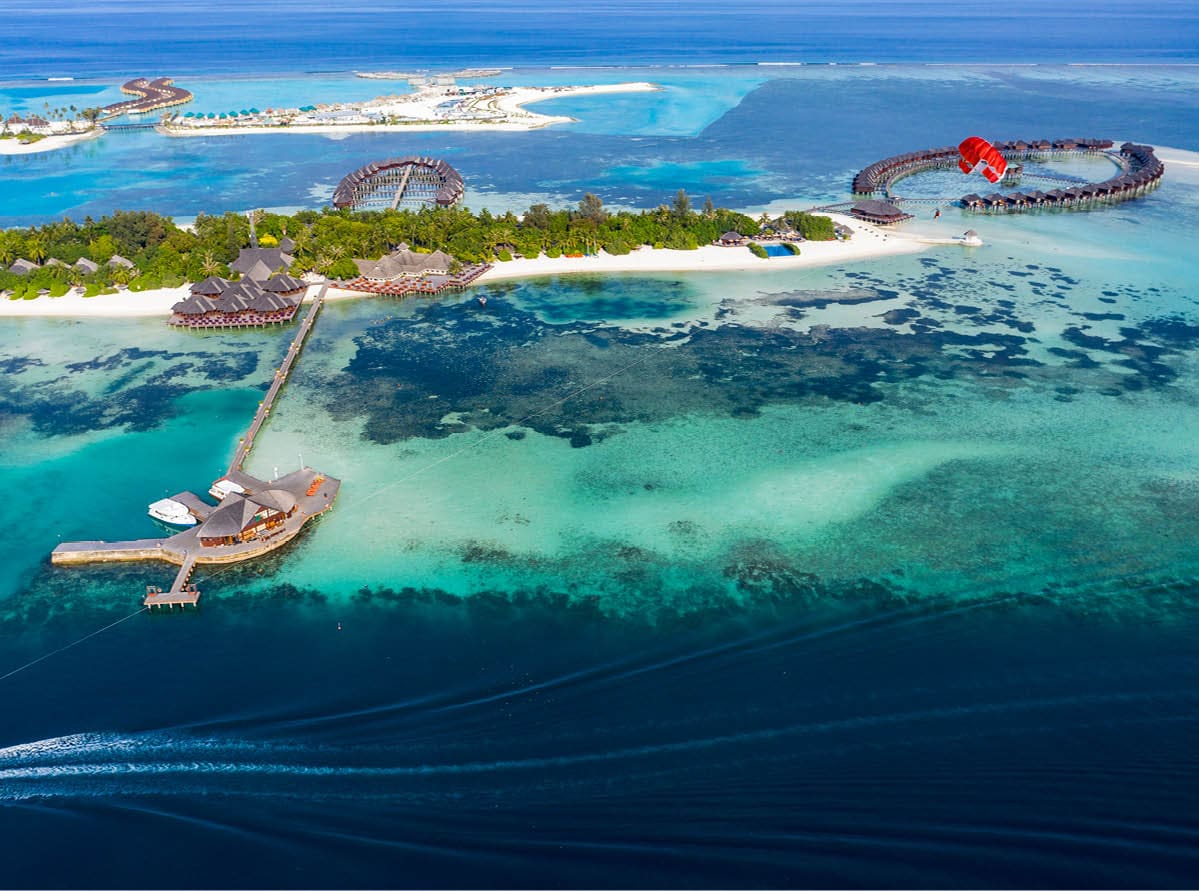 Aerial view, paraglider flies along an atoll of Maldives, South Male Atoll Maldives