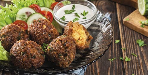 Chickpea falafel balls on a plate with vegetables