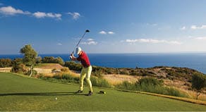 Professional male golf player hitting by driver from tee