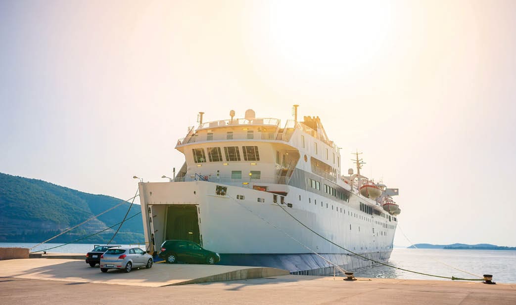 ferry standing on the dock waiting for loading, during the bright sunset