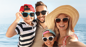 Happy family taking selfie on beach near sea  Summer vacation