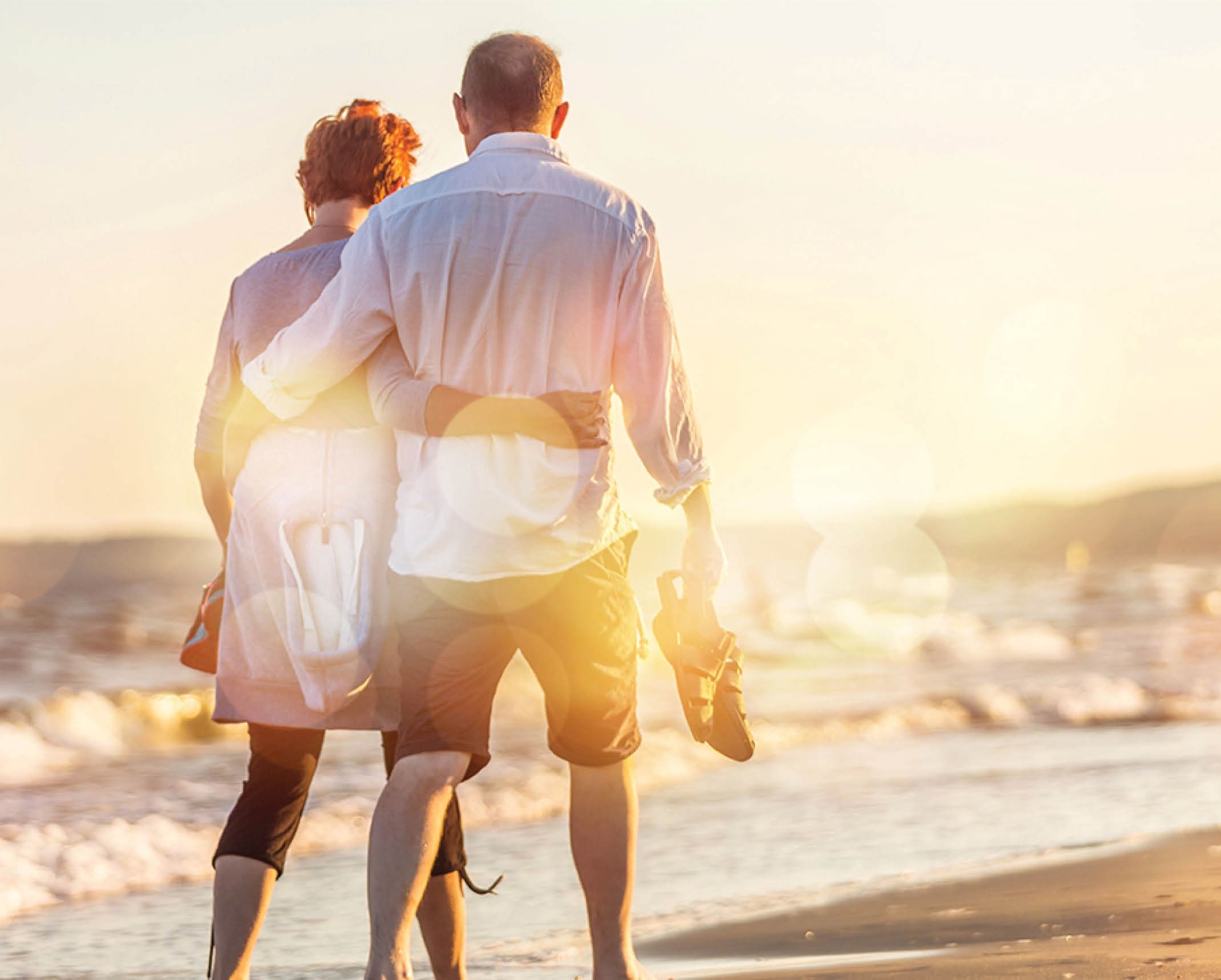 Close-up portrait of an elderly couple hugging on seacoast
