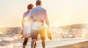 Close-up portrait of an elderly couple hugging on seacoast