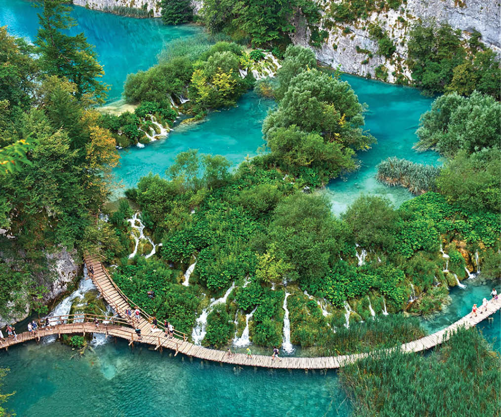 PLITVICE, CROATIA - JULY 29: Tourist enjoy sightseeing the lakes and wonderful landscapes at the Plitvice natural Park in Croatia during the summer holidays, on July 29th, 2016 in Plitvice, Croatia