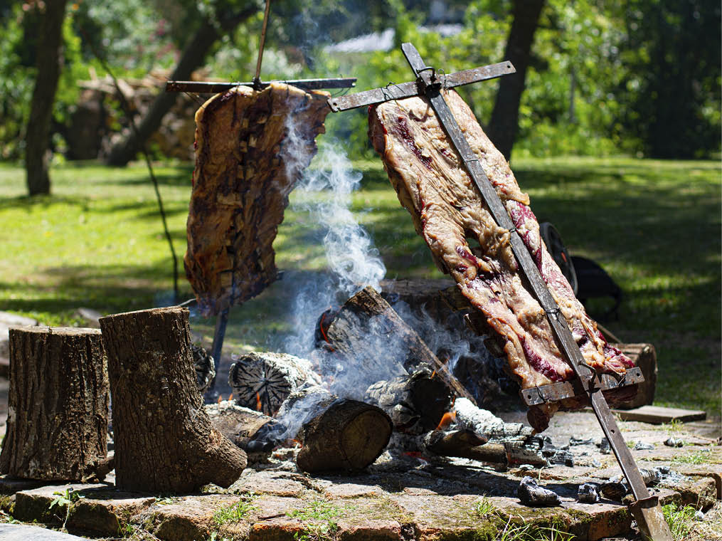 Asado, traditional barbecue dish in Argentina, roasted meat cooked on a crossed vertical grills