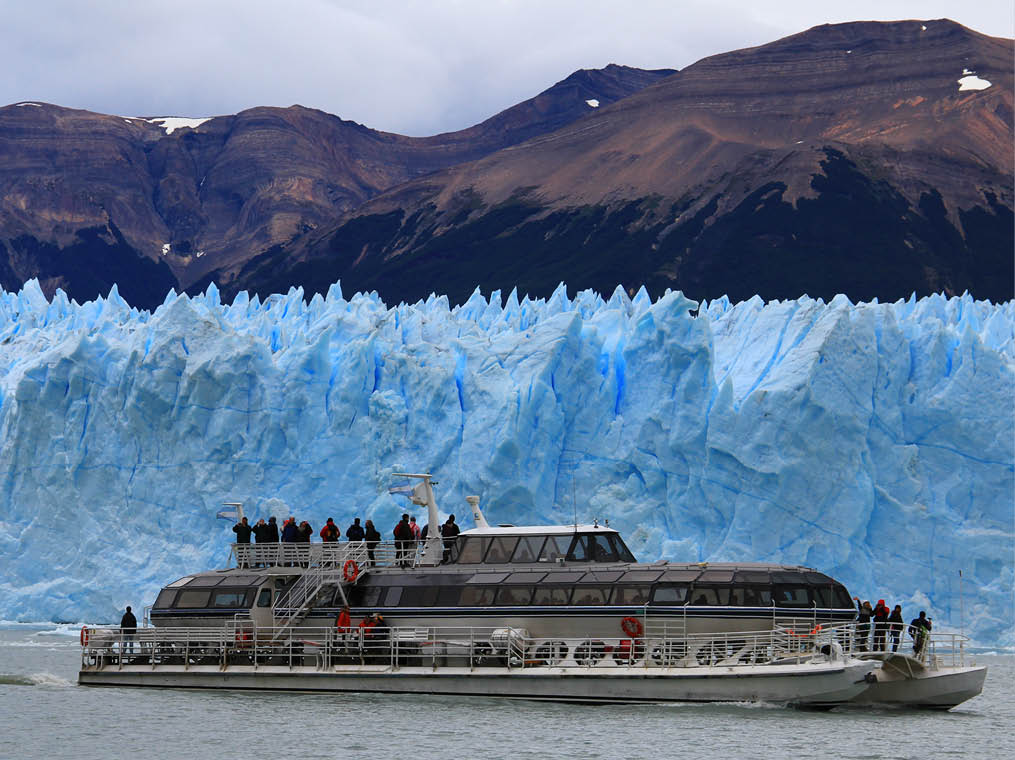 Ship and an iceberg in the background  El Calafate, Patagonia, Argentina