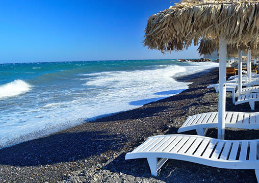 Unique black volcanic pebble beach in Kamari, Santorini