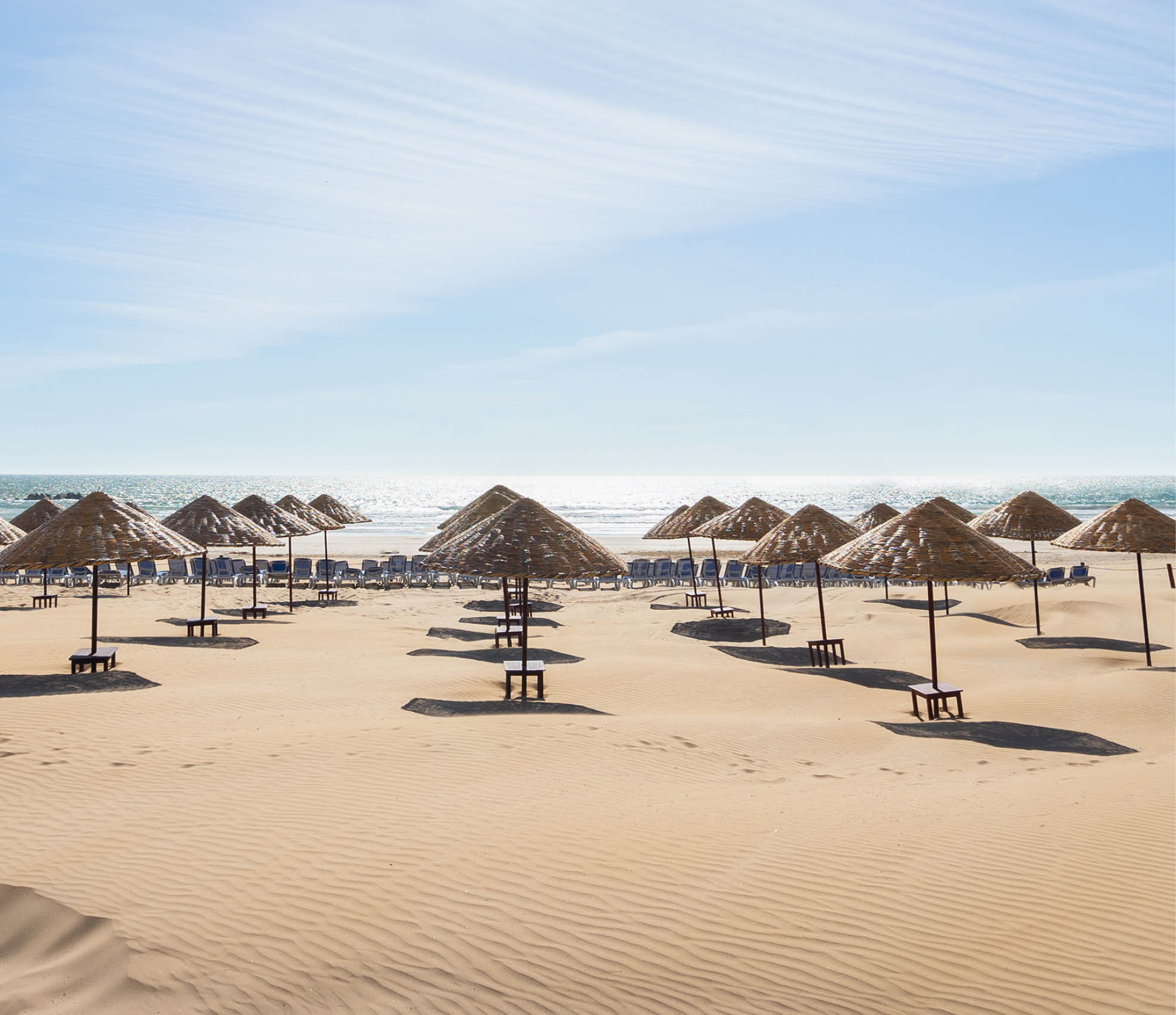 Beach umbrellas on the the beautiful unique sand beach  Vacation and summer holidays concept  Banner and panoramic edition 