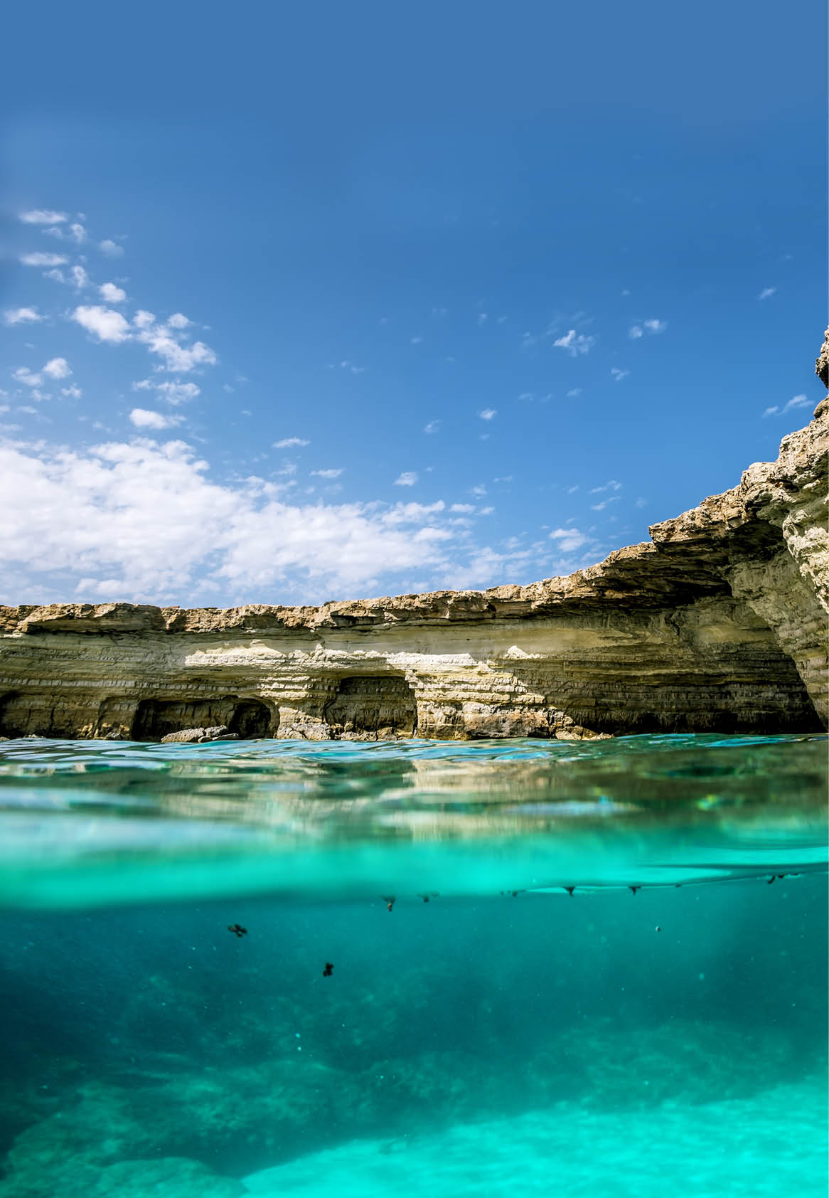 View of the cliffs and sea caves of Cape Greco from under the water and above the water Cyprus