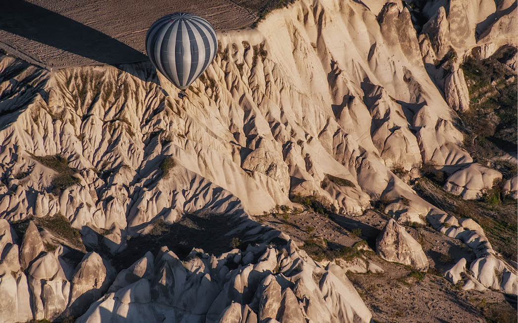 Goreme, Cappadocia, Turkey     Top view of colorful hot air balloons flying over the Love valley on sunrise  