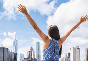 NYC New York city happy freedom woman cheering arms up raised in the sky  Success in business career, goal achievement or carefree freedom successful urban person concept  Banner landscape 