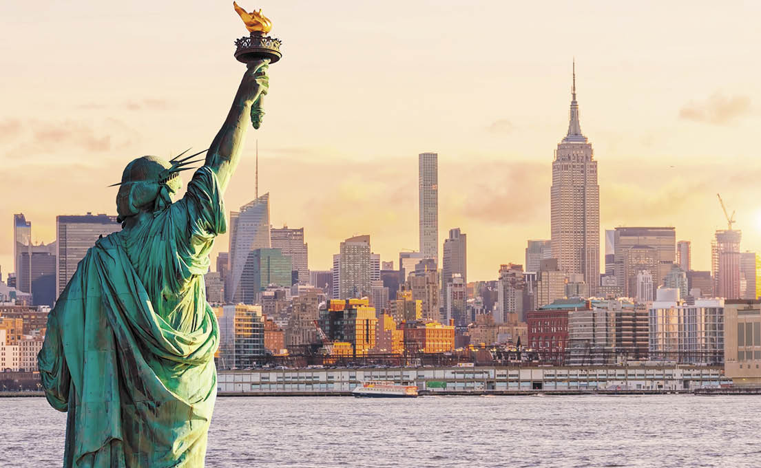 Statue Liberty and  New York city skyline at sunset,  in United States