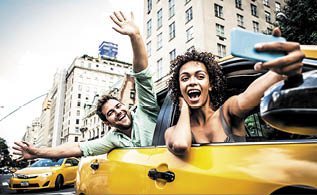 Happy couple on a yellow cab in New york