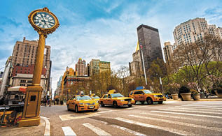 NEW YORK - JULY 21: Yellow taxis on 5th Avenue on July 21 2012 in New York, USA  5th Avenue is a central road of Manhattan, the most expensive shops and apartmens situated here