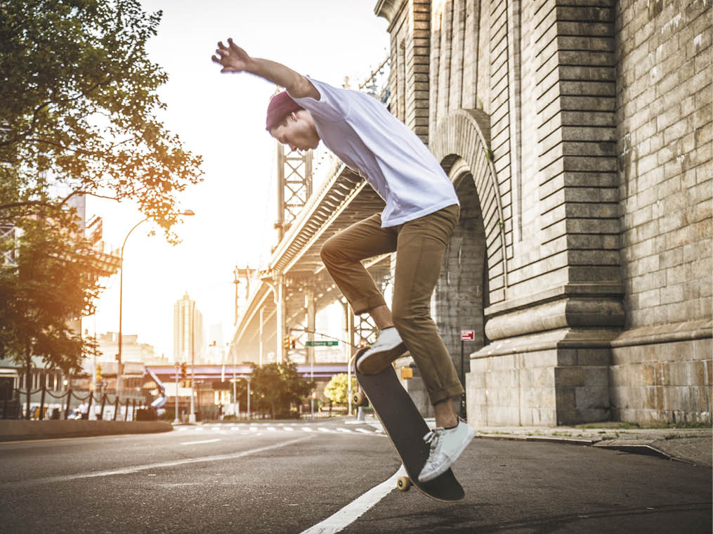 Young adult skating outdoors - Stylish skater boy training in a nNew York skate park, concepts about sport and ifestyle