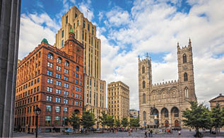 View in late afternoon of Place d'Armes in old Montreal, Montreal, Quebec, Canada, with the monument in memory of Paul de Chomedey, founder of Montreal, the Notre-Dame Basilica, the, New York Life Building and Aldred Building