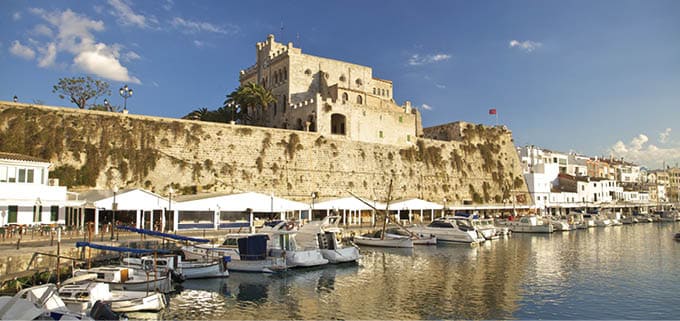 landmark monument historical building and traditional seaport pier port harbour jetty of Ciutadella city with boat and yacht reflect on water sea ocean at Menorca or Minorca Balearic Islands in Spain Europe
