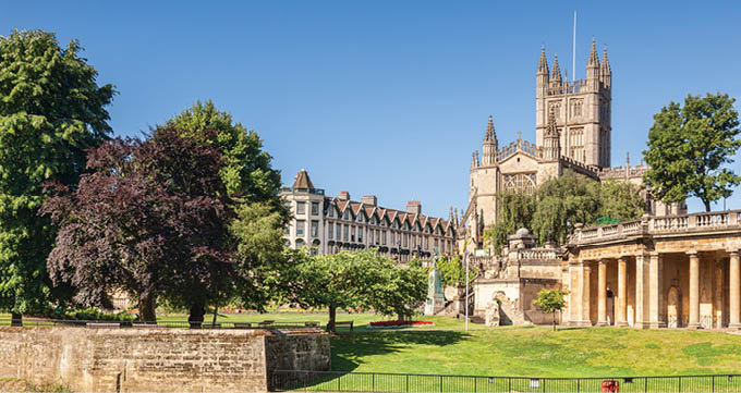 Bath Abbey and the Orangerie on the banks of the River Avon, on a beautiful summer morning with perfectly clear blue sky  Bath, Somerset, England, UK