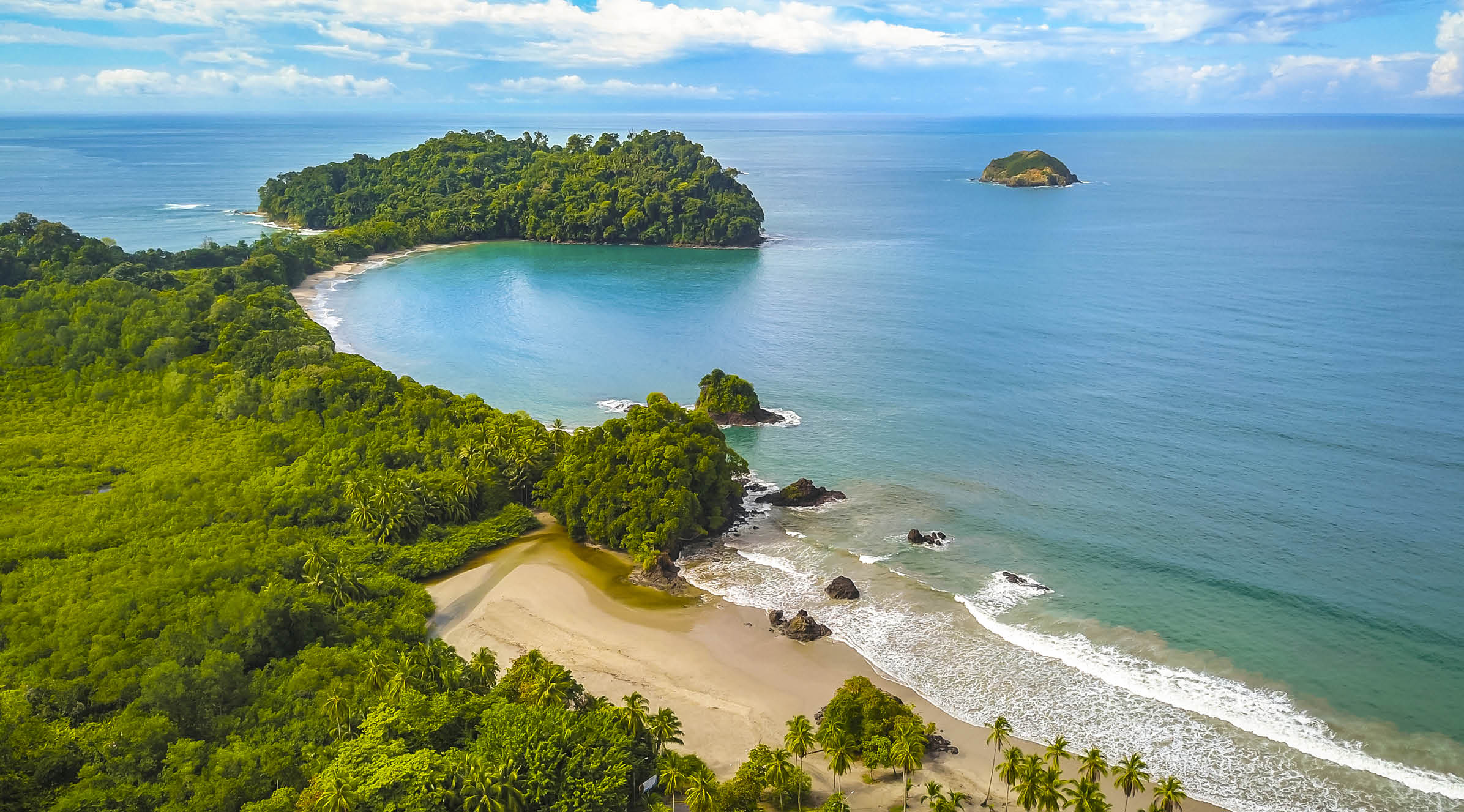 Aerial view of Manuel Antonio National Park in Costa Rica. The most famous Tourist Attraction and Nature Reserve with lots of Wildlife, Tropical Plants and perfect Beaches on the Pacific Coast.