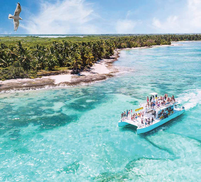 aerial view of a boat on excursion from La Romana to Saona via Punta Cana heading along beautiful caribbean beaches, Dominican Republic