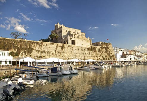 landmark monument historical building and traditional seaport pier port harbour jetty of Ciutadella city with boat and yacht reflect on water sea ocean at Menorca or Minorca Balearic Islands in Spain Europe