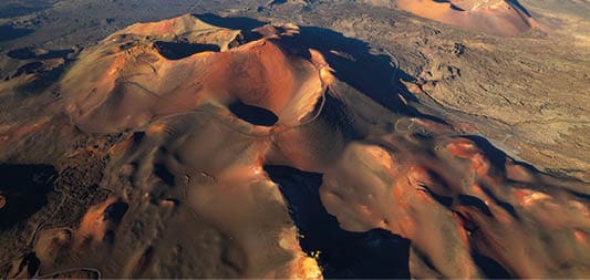 Amazing panoramic landscape of volcano craters in Timanfaya national park. Popular touristic attraction in Lanzarote island, Canary islands, Spain