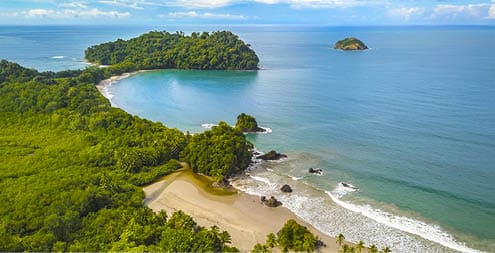 Aerial view of Manuel Antonio National Park in Costa Rica. The most famous Tourist Attraction and Nature Reserve with lots of Wildlife, Tropical Plants and perfect Beaches on the Pacific Coast.