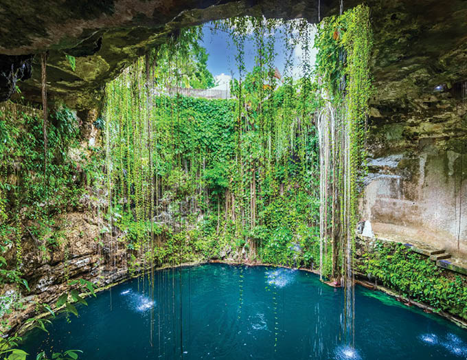 Ik-Kil Cenote, Mexico. Lovely cenote in Yucatan Peninsulla with transparent waters and hanging roots. Chichen Itza, Central America.