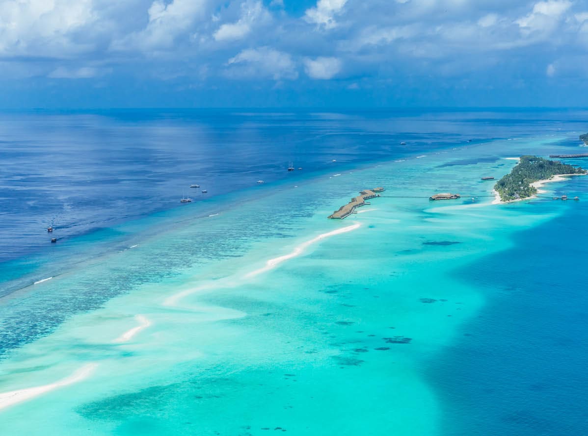 Aerial view on Maldives island, Ari atoll. Tropical islands and atolls in Maldives from aerial view. Summer vacation holiday landscape background.