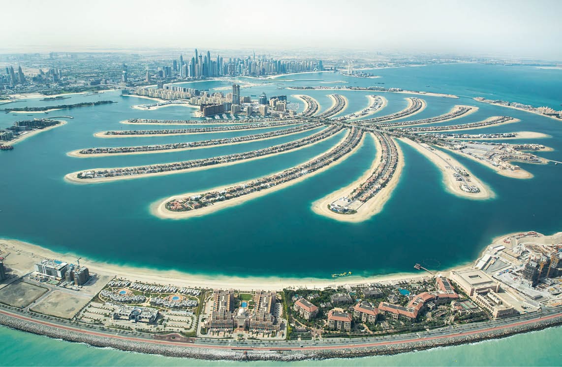 Aerial view of Palm Jumeirah man made island and Dubai Marina and JBR district on a sunny day. Dubai, UAE.