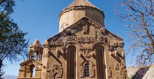 Eastern side of medieval Armenian Cathedral of Holy Cross & its bas-reliefs, Akdamar island, Van Lake, Geva Turkey. Church is richly decorated by bas-reliefs. It was built in 921 as church for king