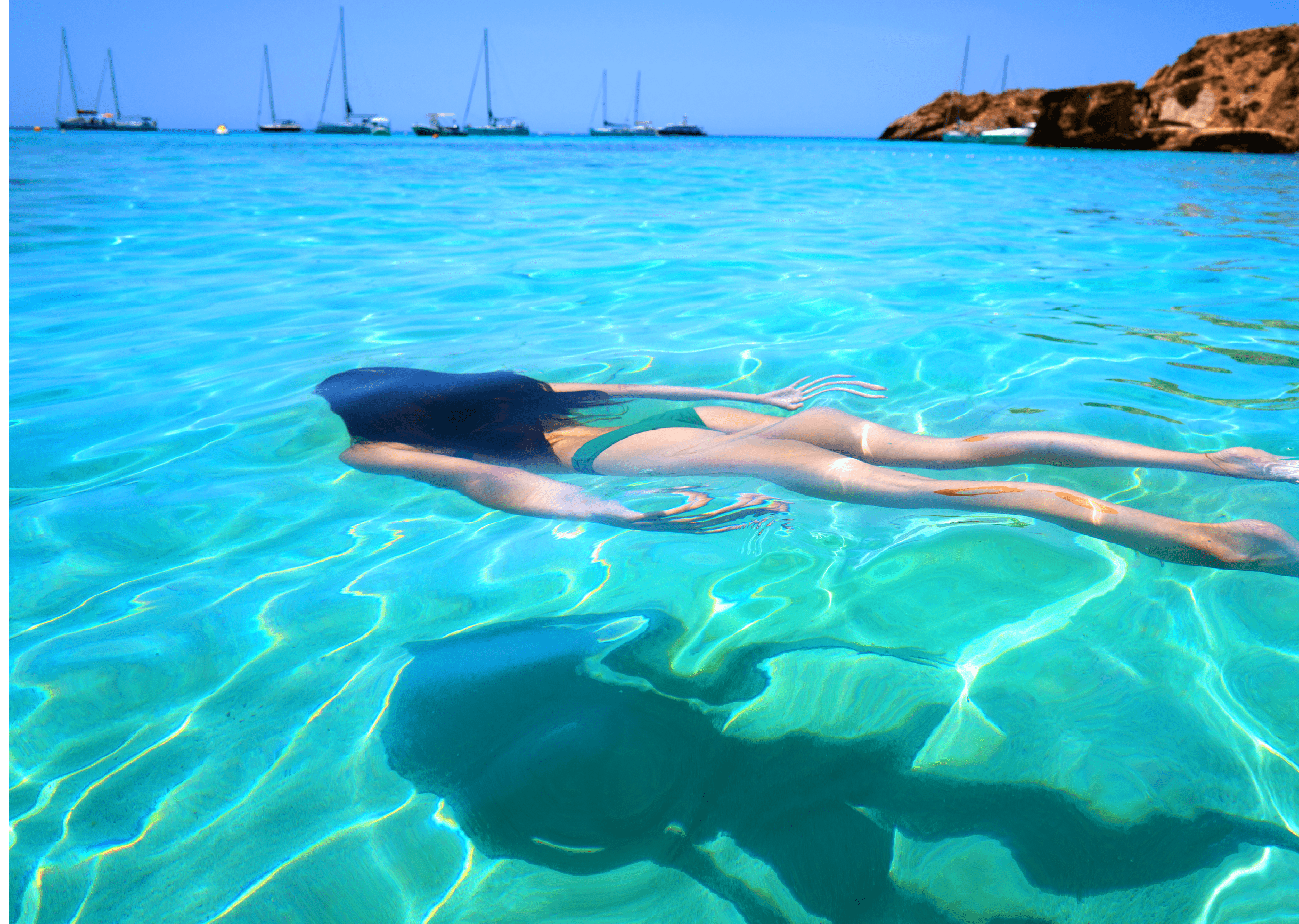 Ibiza bikini girl swimming clear water beach of Balearic Islands