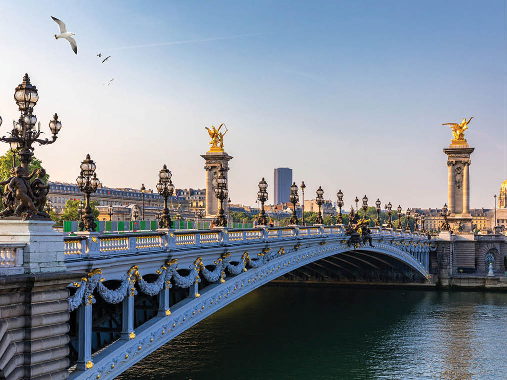 Pont Alexandre III bridge over river Seine in the sunny summer morning  Bridge decorated with ornate Art Nouveau lamps and sculptures  The Alexander III Bridge across Seine river in Paris, France 