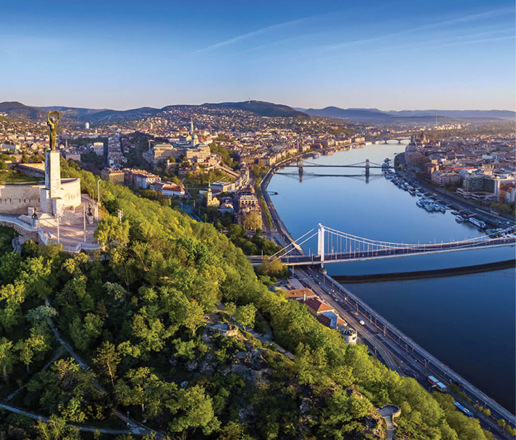 Budapest, Hungary - Aerial panoramic skyline view of Budapest at sunrise  This view includes the Statue of Liberty, Elisabeth Bridge, Buda Castle Royal Palace and Szechenyi Chain Bridge with blue sky