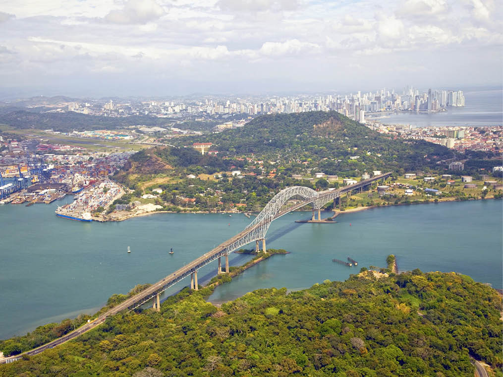Aerial view of the Bridge of the Americas at the Pacific entrance to the Panama Canal with Panama City in the background 
