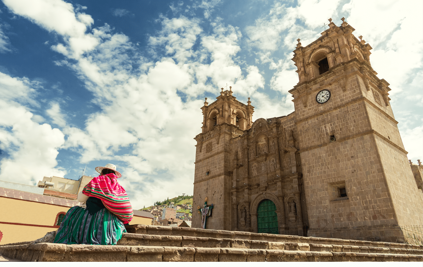 Woman with keperina (bag on her back) sitting on the steps of the Cathedral of Puno (Peru)