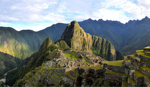 Panorama of Machu Picchu terraces, watcher's hut and Wuayna Picchu with shadow in early morning light  Machu Picchu is the famous lost city of the Incas near the river Urubamba located in the region of the sacred valley of Cuzco  Machu Picchu is a UNESCO world heritage site and one of the 7 new world wonders 