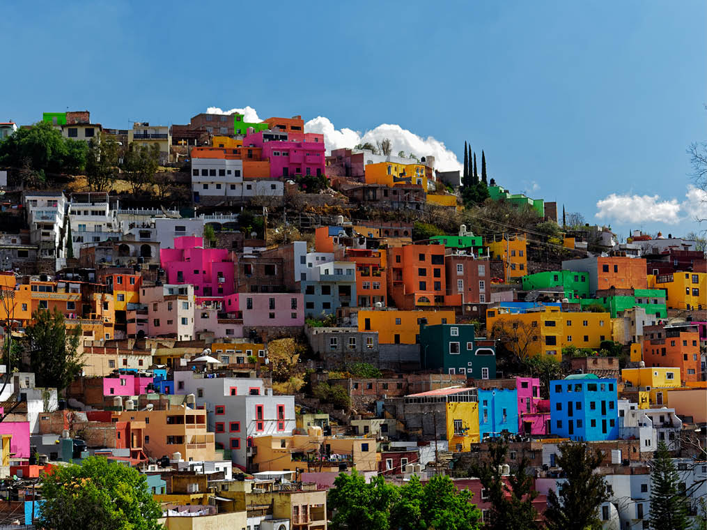 Colorful neighborhood perched on a hill with sky and cloud background in the beautiful, historic city of Guanajuato, Gto , Mexico