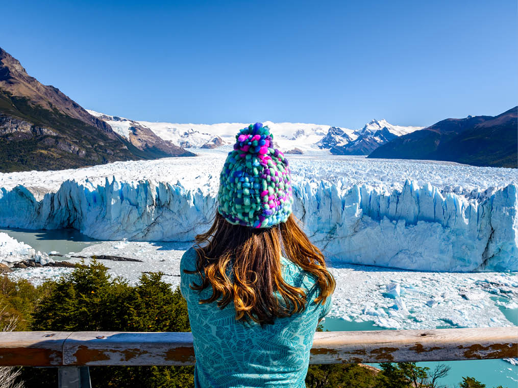 A female tourist is standing in front of Perito Moreno Glacier, Los Glaciares National Park in Santa Cruz Province, Argentina