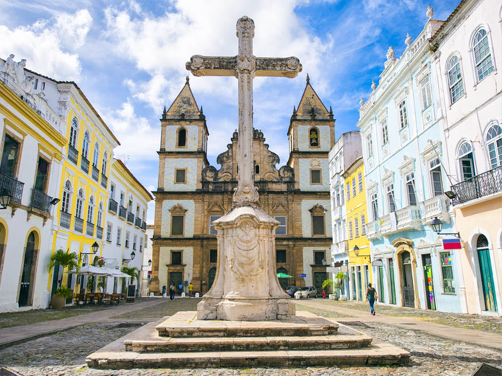 Bright view of Pelourinho in Salvador, Brazil, dominated by the large colonial Cruzeiro de Sao Francisco Christian stone cross in the Praça Anchieta