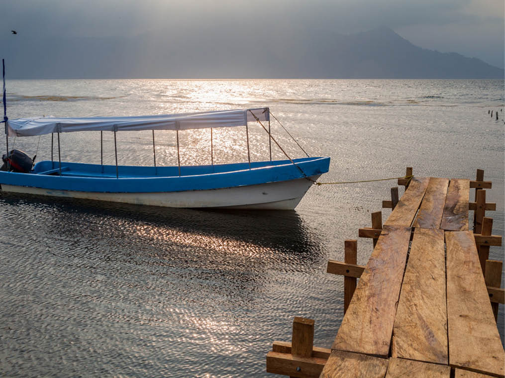 Wooden piers and a boat at lake Yojoa, Honduras