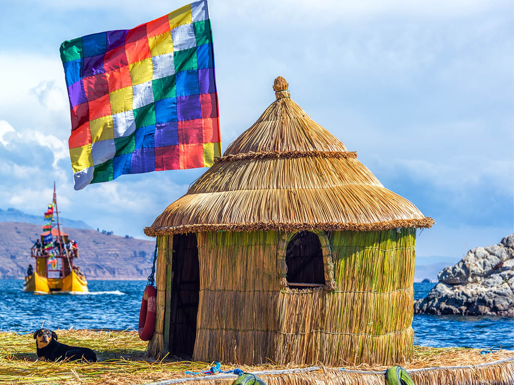 Whiphala flag on a hut on a floating island on Lake Titicaca near Copacabana, Bolivia