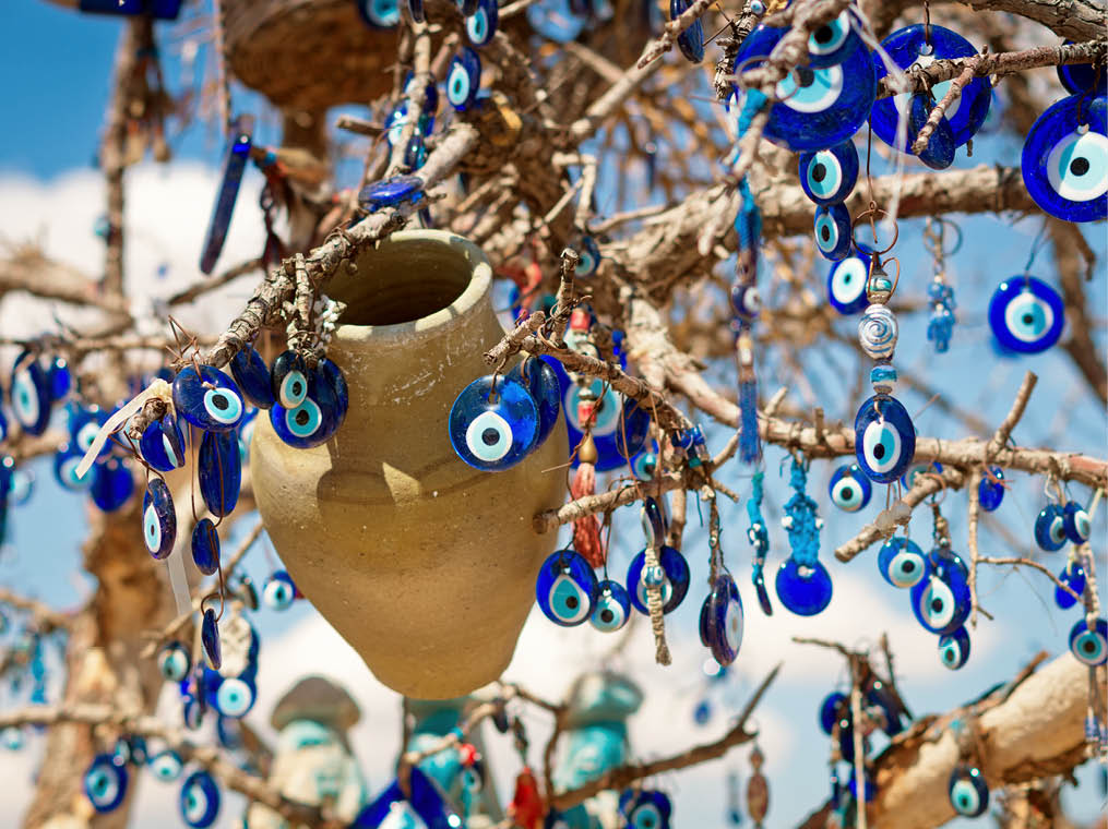 A nazar, charms to ward off the evil eye , on the branches of a tree in Cappadocia, Turkey