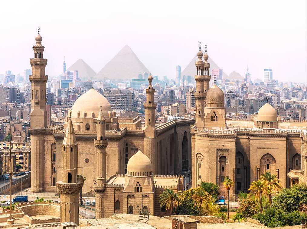 The Mosque-Madrassa of Sultan Hassan and the Pyramids in the background, Cairo, Egypt 