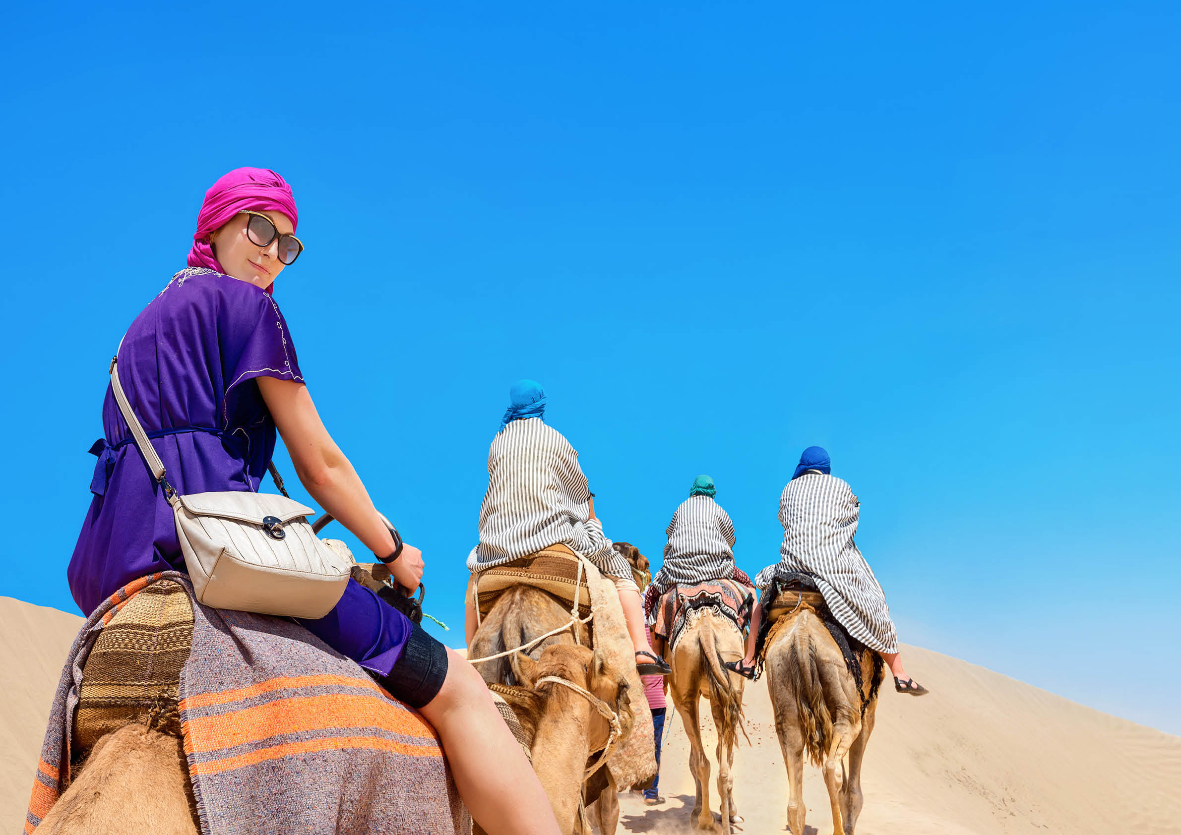 Group of tourists riding on camels  Safari tourism  Sahara desert, Tunisia, North Africa 