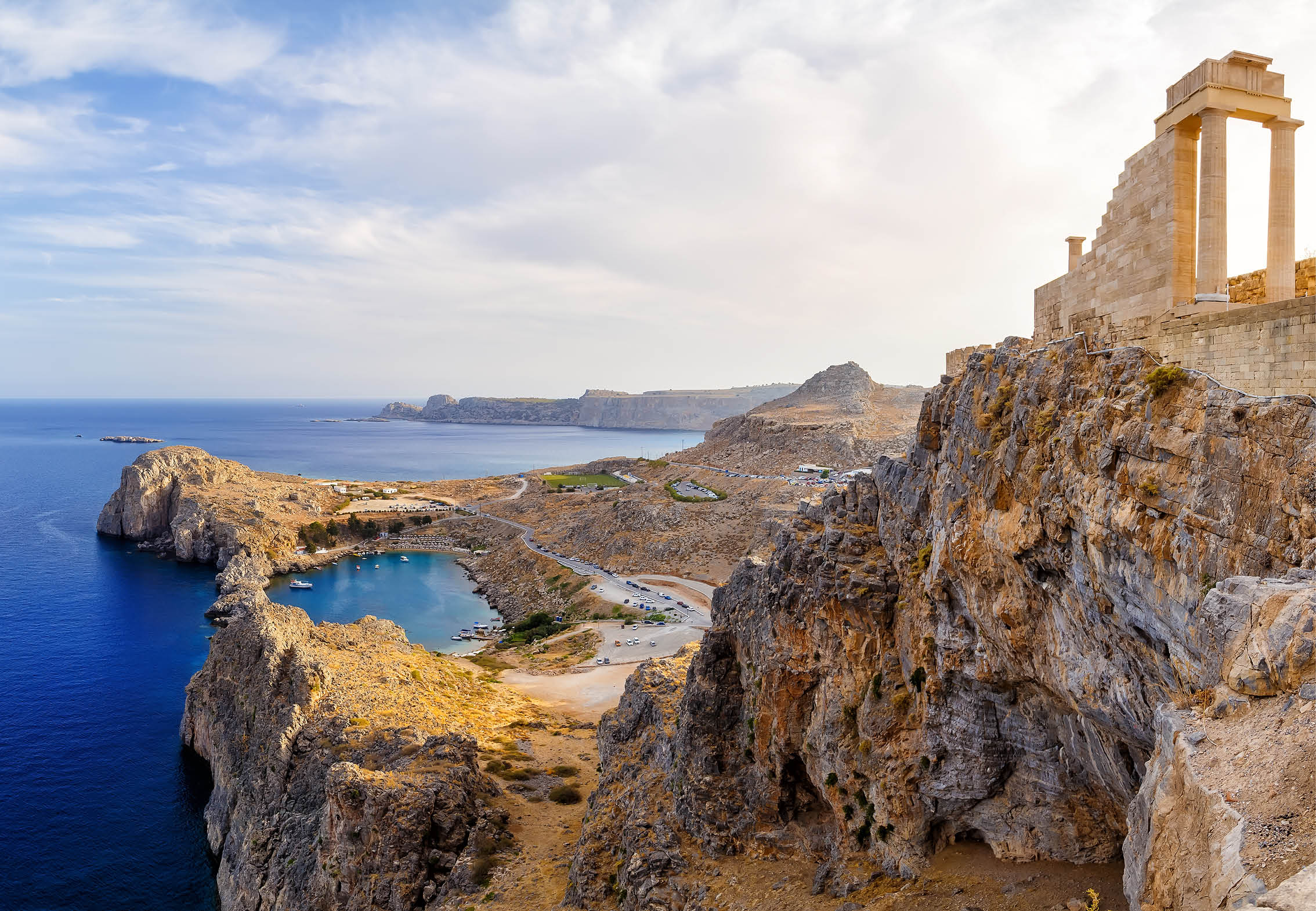 Greece  Rhodes  Acropolis of Lindos  Doric columns of the ancient Temple of Athena Lindia the IV century BC and the bay of St  Paul